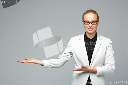 Image of Business woman showing hand sign to side.