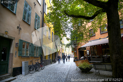 Image of STOCKHOLM, SWEDEN - AUGUST 19, 2016: View of narrow street and c