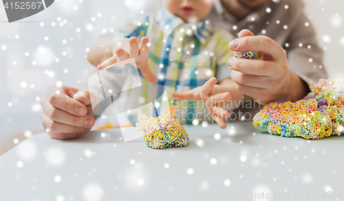 Image of father and son playing with ball clay at home