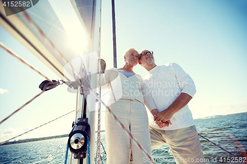 Image of senior couple hugging on sail boat or yacht in sea