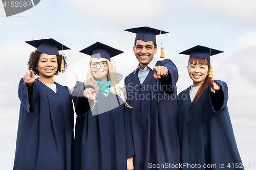 Image of happy students or bachelors pointing finger at you