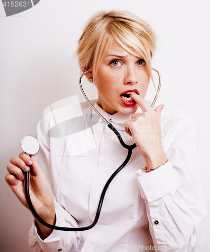 Image of funny doctor with stethoscope, smiling blond woman medical equipment showing on white background