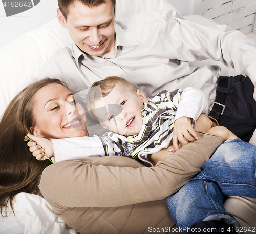 Image of young happy modern family smiling together at home. lifestyle people concept, father holding baby son