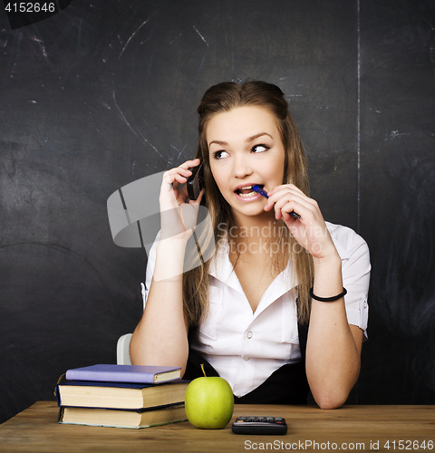 Image of portrait of happy cute student with book in classroom