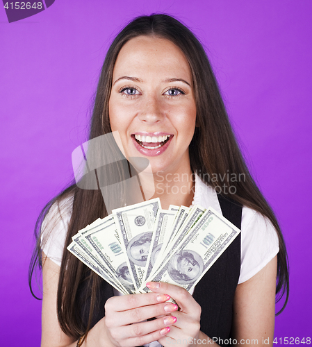 Image of pretty young brunette real modern woman with money cash on blue background happy smiling, lifestyle people concept