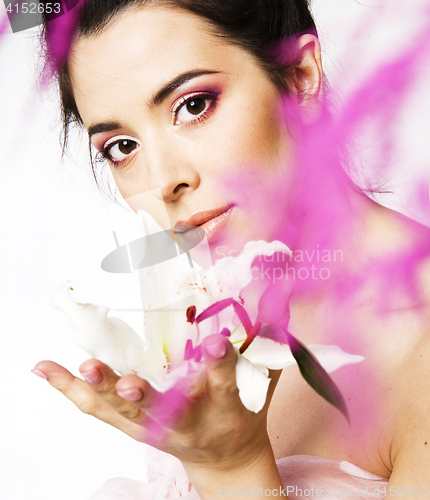 Image of beauty young brunette woman with flower close up, rose petails spa