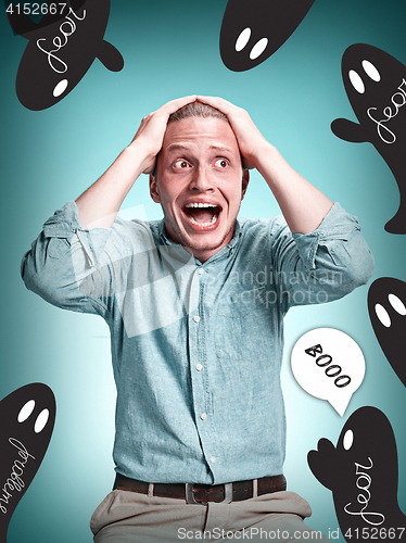 Image of The disappointed young man over blue background