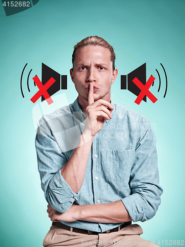 Image of The serious young man over blue background