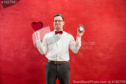 Image of Young funny man with abstract heart and clock