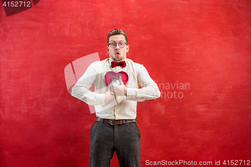 Image of Young funny man with abstract heart and clock