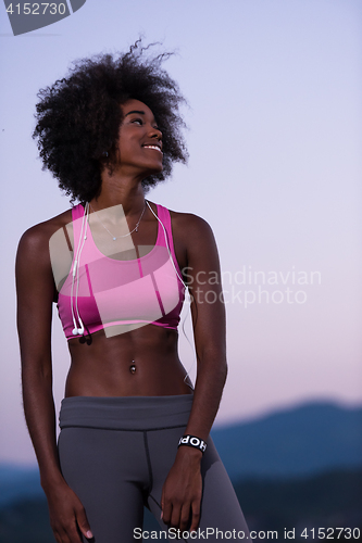 Image of portrait of african american woman jogging in nature