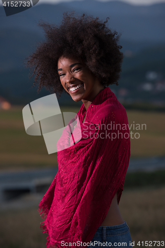 Image of outdoor portrait of a black woman with a scarf