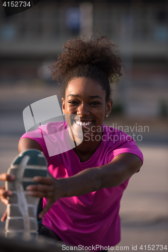 Image of African American woman doing warming up and stretching