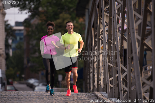 Image of multiethnic couple jogging in the city