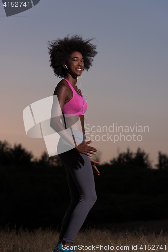 Image of black woman is doing stretching exercise relaxing and warm up