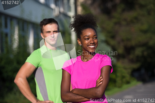 Image of portrait of young multietnic jogging couple ready to run