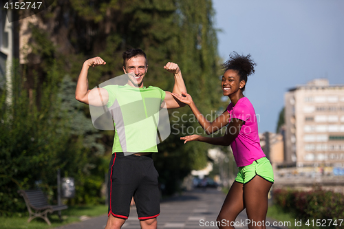 Image of portrait of young multietnic jogging couple ready to run