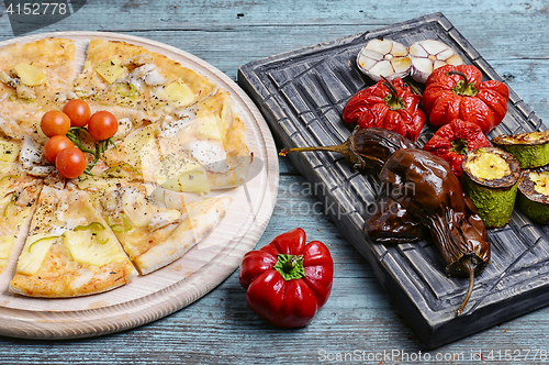 Image of pizza and baked vegetables
