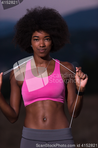 Image of portrait of african american woman jogging in nature