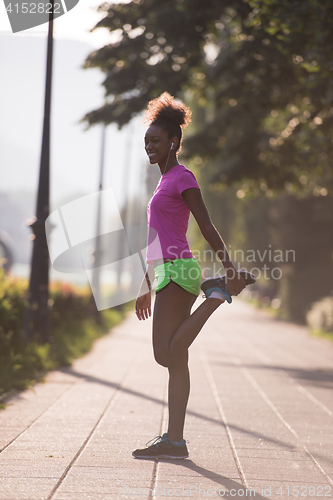 Image of Black woman doing warming up and stretching