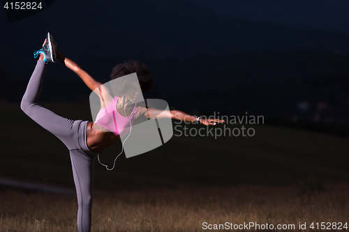 Image of black woman doing yoga  in the nature