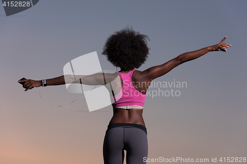 Image of young black girl dances outdoors