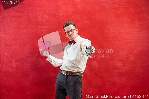 Image of Young funny man with abstract heart and clock