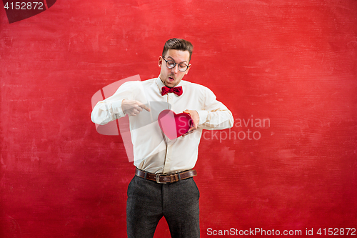 Image of Young funny man with abstract heart and clock