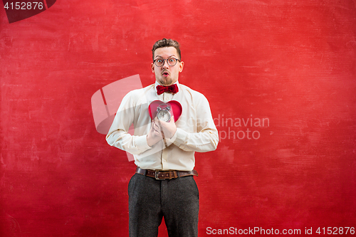 Image of Young funny man with abstract heart and clock