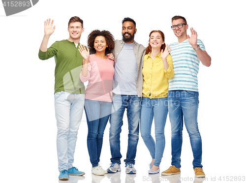 Image of international group of happy people waving hands