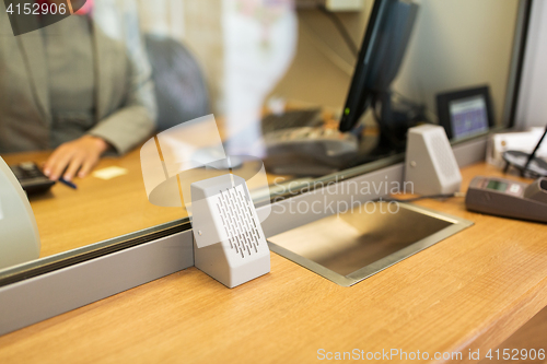 Image of clerk at bank office or currency exchanger