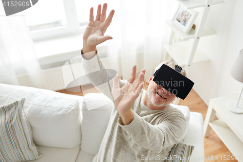 Image of old man in virtual reality headset or 3d glasses