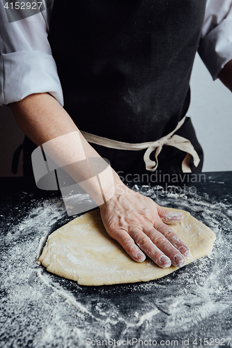 Image of Person rolling homemade cookie dough