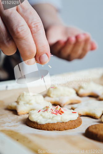 Image of Person decorating cookies