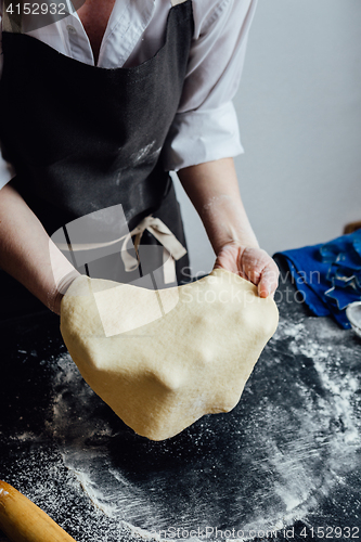 Image of Person rolling homemade cookie dough