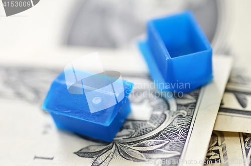 Image of Little plastic house on US dollar banknote