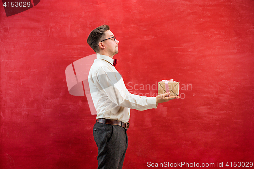 Image of Young funny man with gift