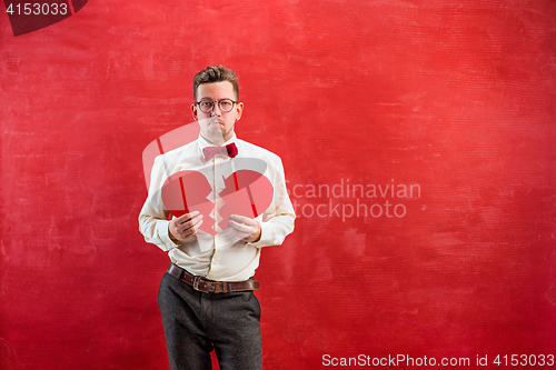 Image of Young funny man with abstract broken heart and clock