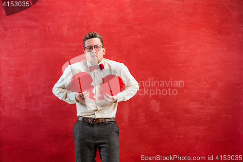 Image of Young funny man with abstract broken heart and clock