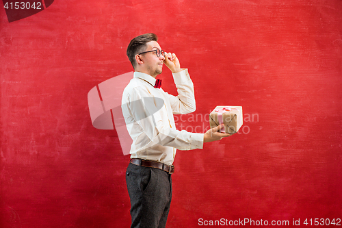 Image of Young funny man with gift