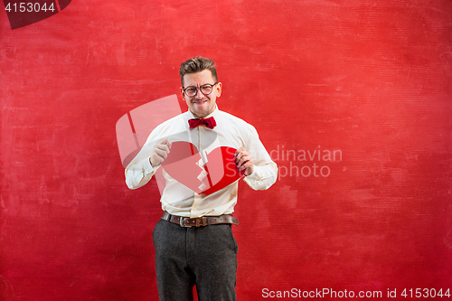 Image of Young funny man with abstract broken heart