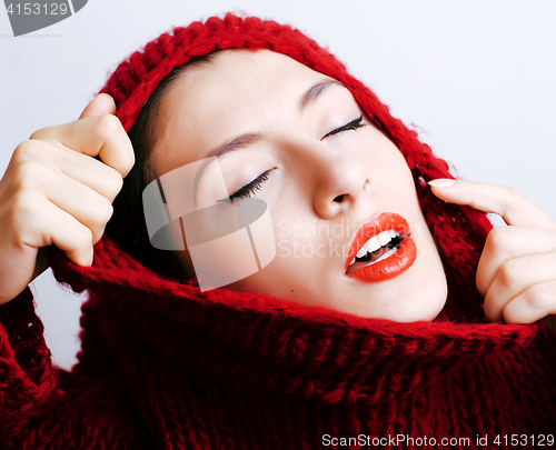 Image of young pretty woman in sweater and scarf all over her face, lifes