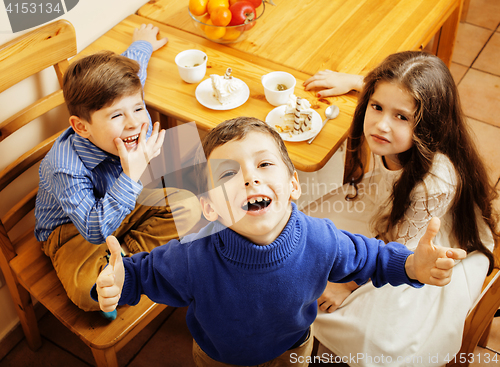 Image of little cute boys eating dessert on wooden kitchen. home interior. smiling adorable friendship together forever friends, lifestyle people concept