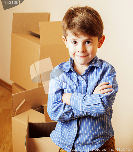 Image of little cute boy in empty room, remoove to new house. home alone,