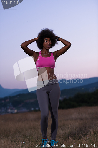 Image of portrait of african american woman jogging in nature