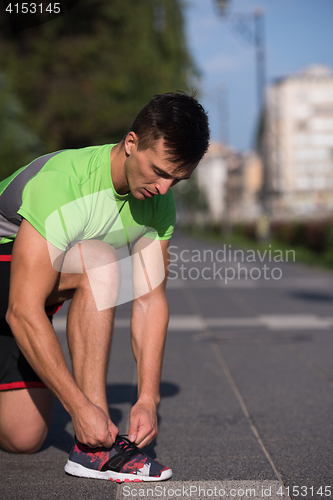 Image of Young athlete, runner tie shoelaces in shoes