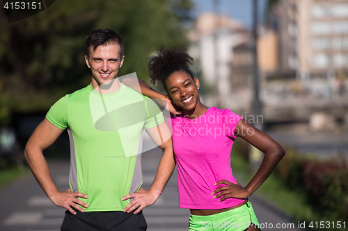 Image of portrait of young multietnic jogging couple ready to run