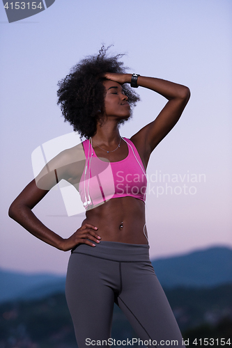 Image of portrait of african american woman jogging in nature