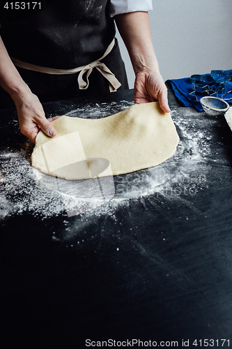 Image of Person rolling homemade cookie dough