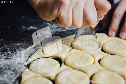 Image of Person shaping cookies with shot glass